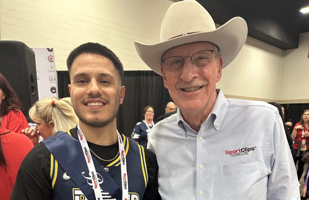 Battle of the Hair Winner and scholarship recipient Pablo with Gordon Logan, Sport Clips Chairman and Founder.